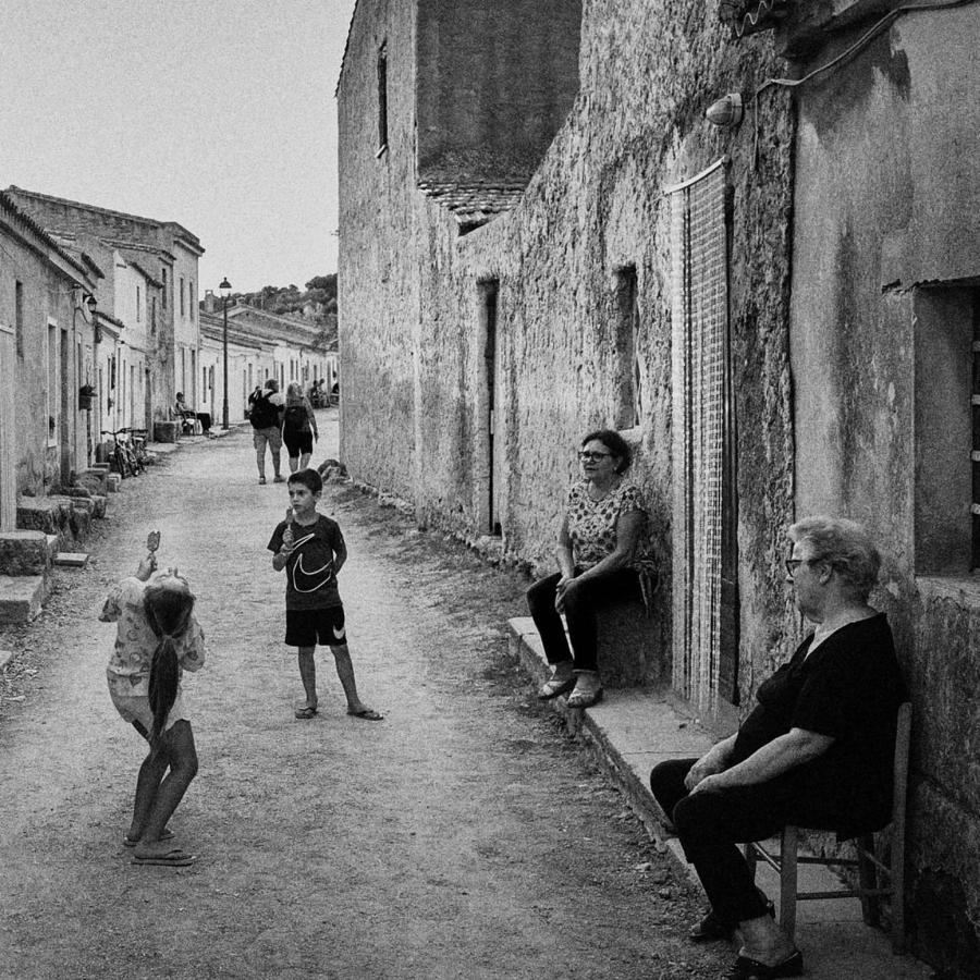 A convivial family gathering in San Salvatore del Sinis, Sardinia.